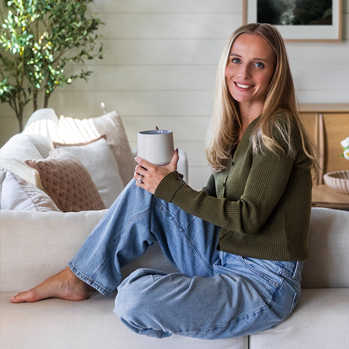 Sophie sitting at home with a mug